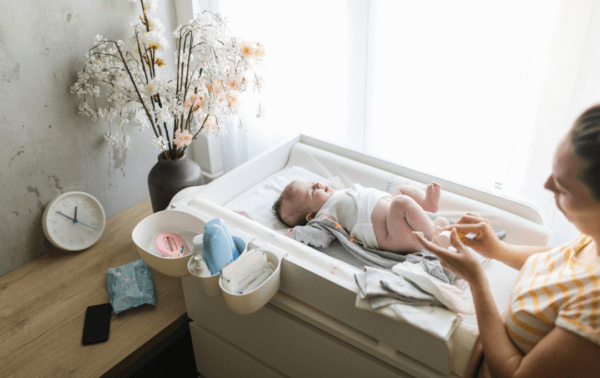 Mother changing baby's diaper.