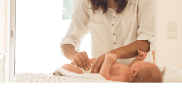 Mom changing her baby's diaper.